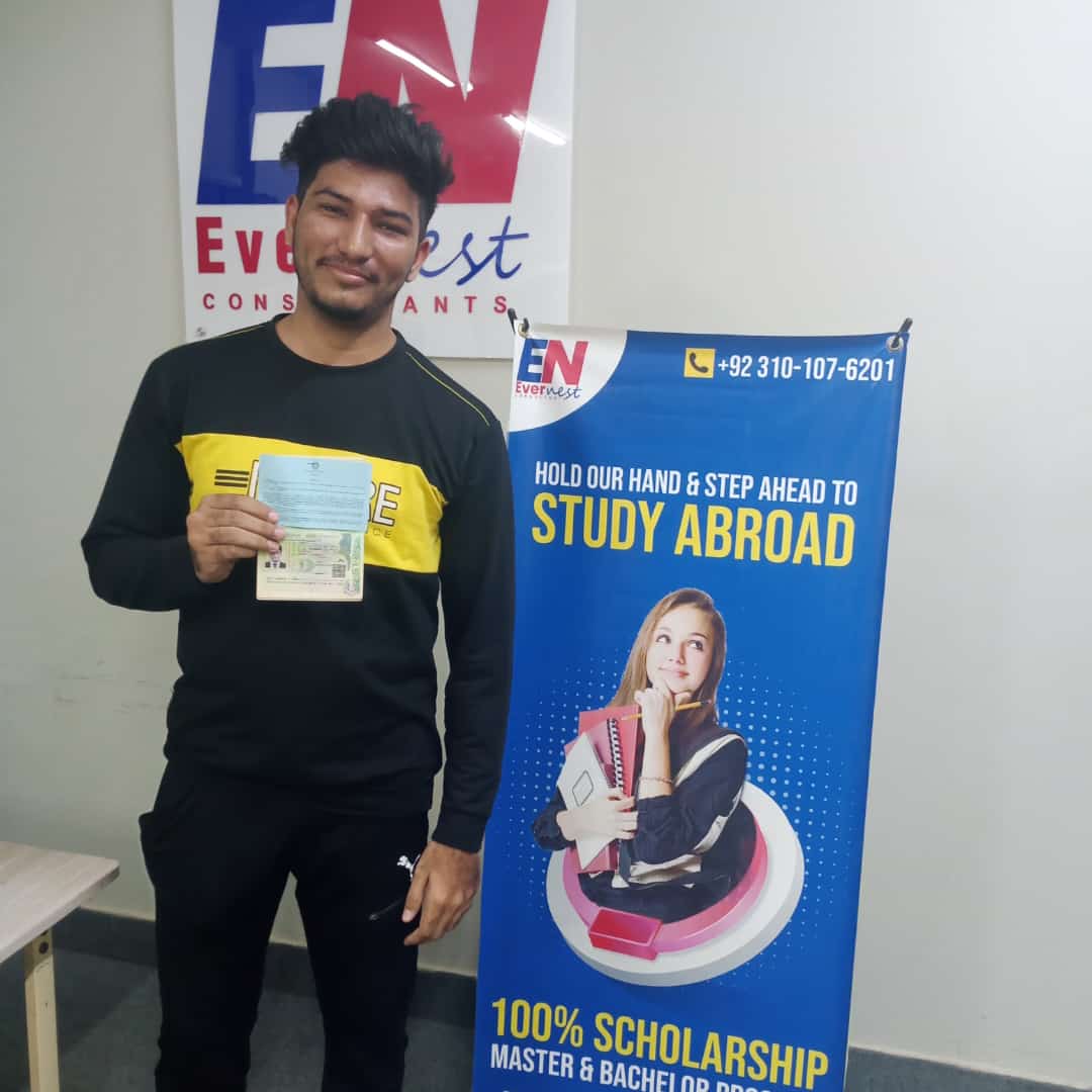 Success Story 1 holding visa approval documents