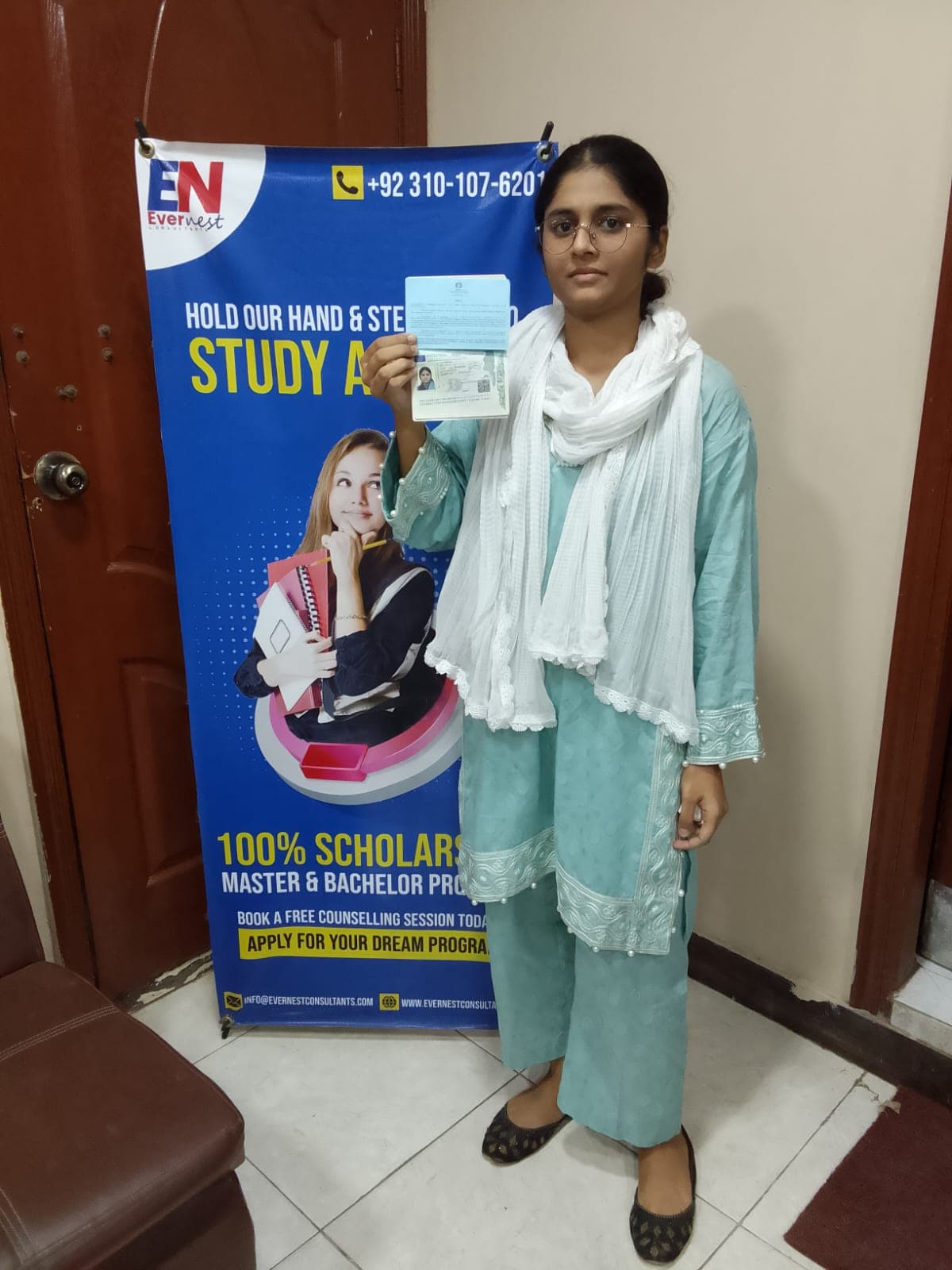 Success Story 2 holding visa approval documents